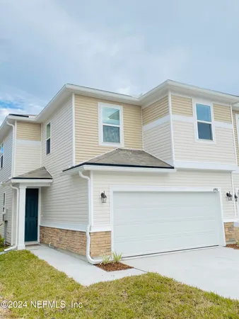 a view of a house with a backyard