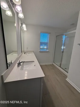 a bathroom with a sink vanity and a mirror