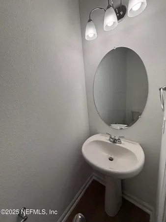 a bathroom with a sink and mirror