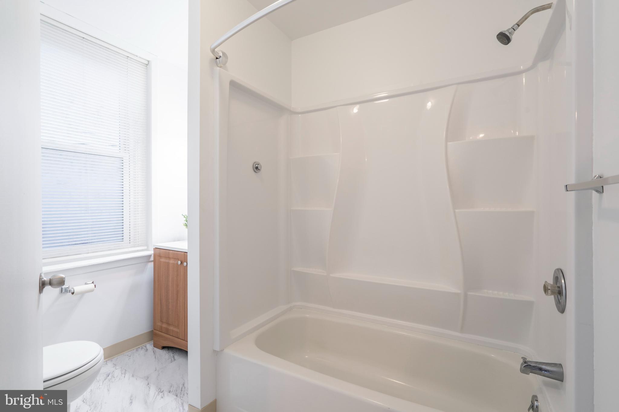 420 Prospect Avenue, Unit 1 Bridgeport, PA 19405 - Photo 12 of 24 a bathroom with a bathtub and a shower