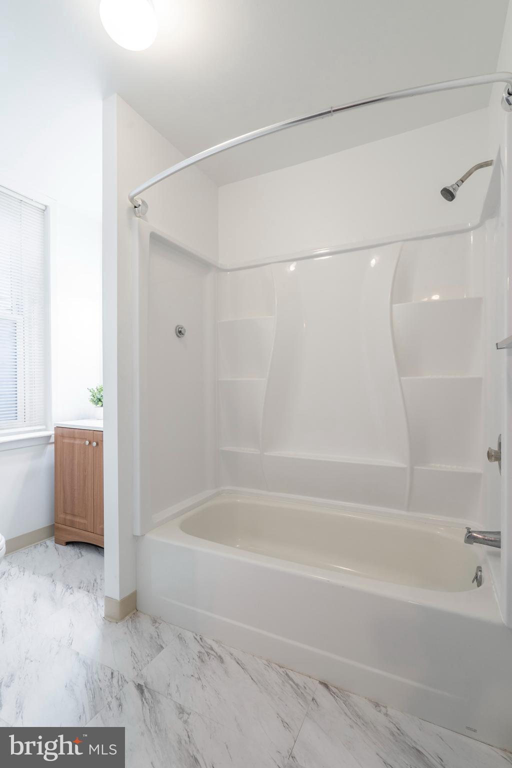 420 Prospect Avenue, Unit 1 Bridgeport, PA 19405 - Photo 13 of 24 a bathroom with a shower and a bath tub