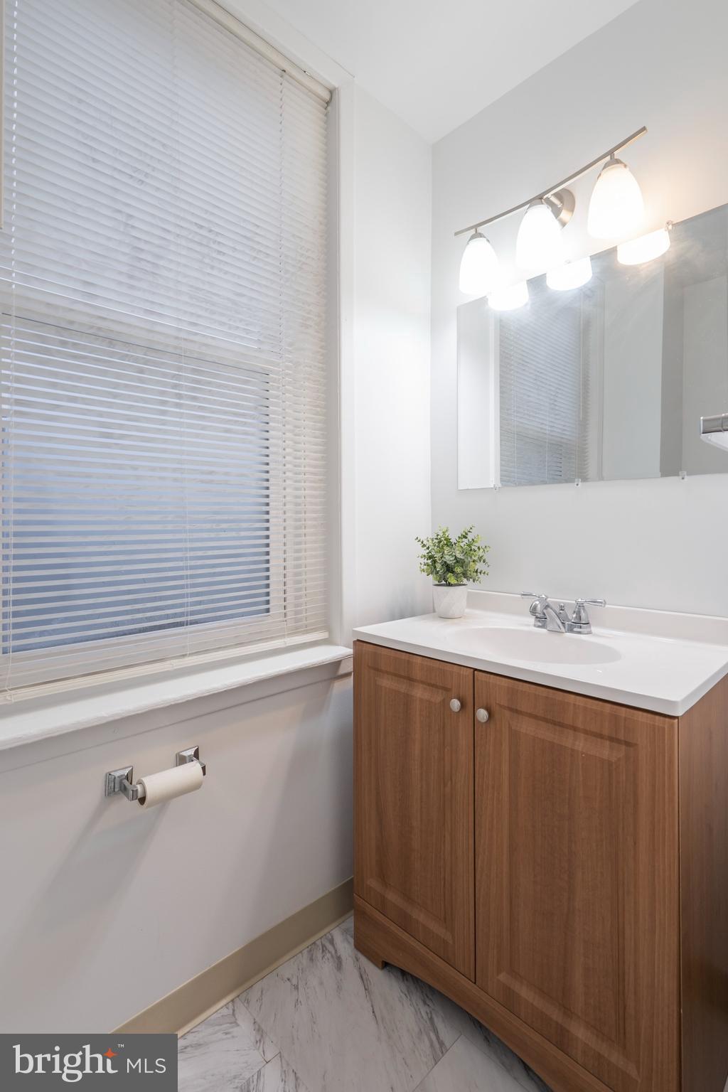 420 Prospect Avenue, Unit 1 Bridgeport, PA 19405 - Photo 14 of 24 a bathroom with a sink and a mirror