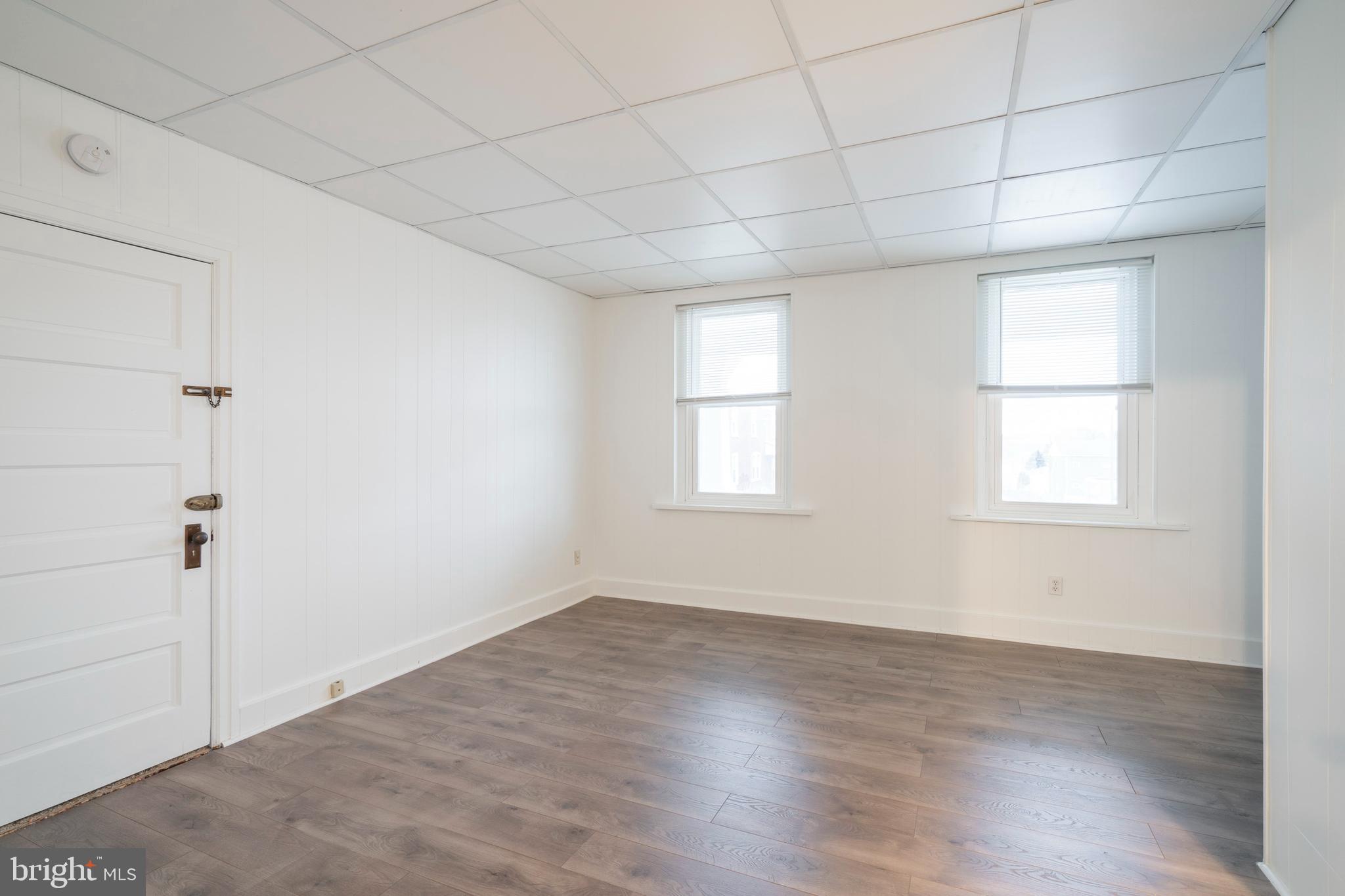 420 Prospect Avenue, Unit 1 Bridgeport, PA 19405 - Photo 15 of 24 an empty room with wooden floor and windows