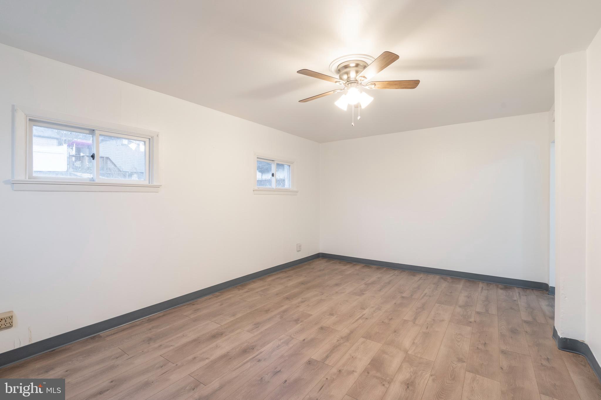 420 Prospect Avenue, Unit 1 Bridgeport, PA 19405 - Photo 3 of 24 a view of an empty room with wooden floor and a ceiling fan