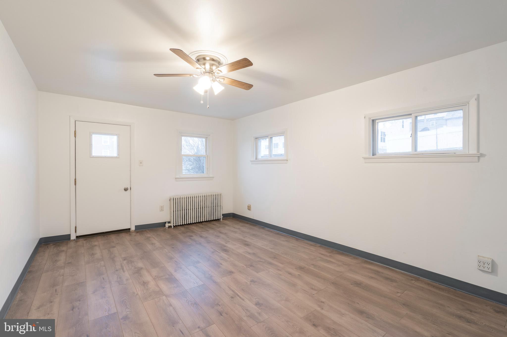 420 Prospect Avenue, Unit 1 Bridgeport, PA 19405 - Photo 4 of 24 a view of an empty room with wooden floor and a window