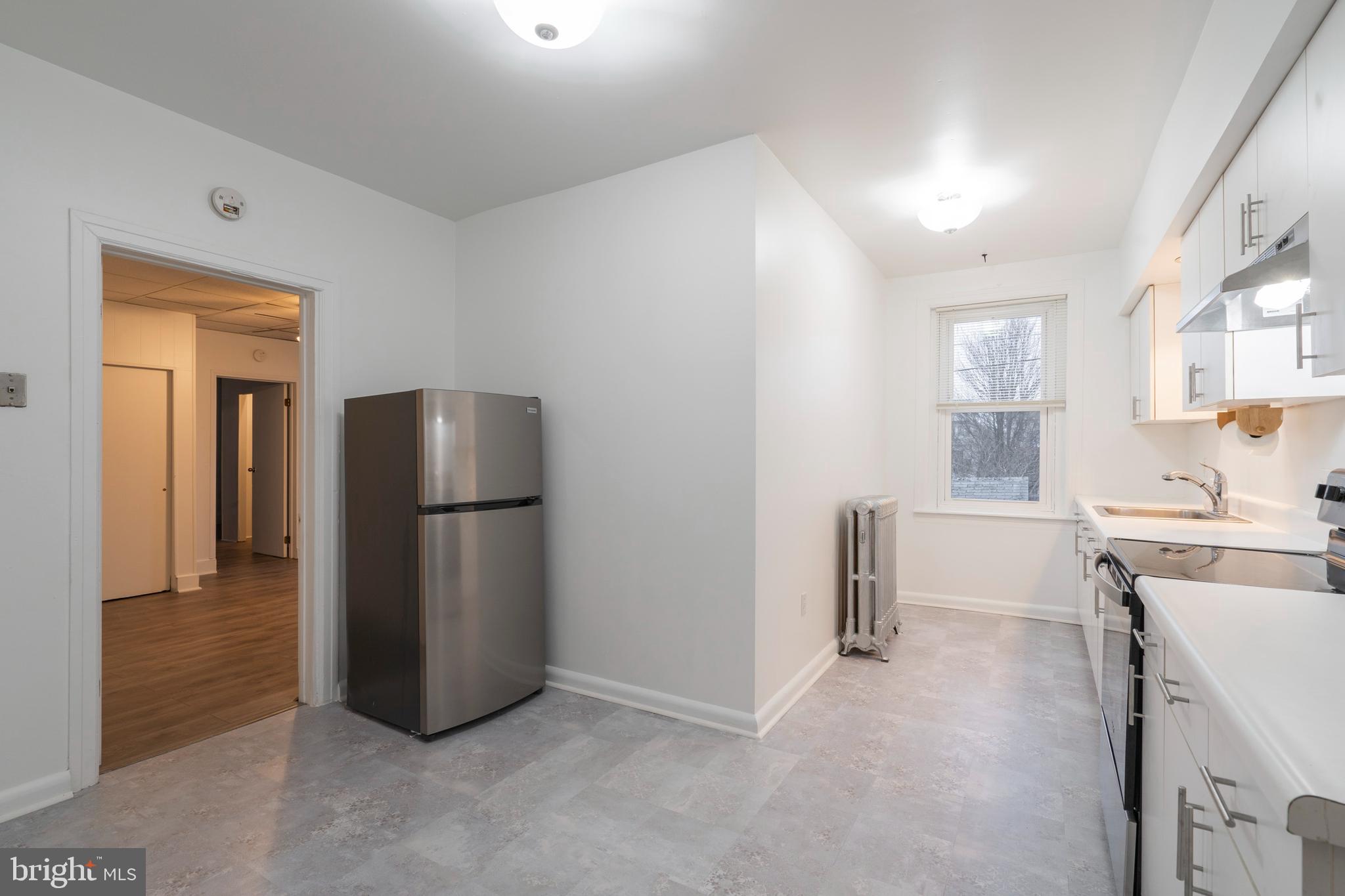 420 Prospect Avenue, Unit 1 Bridgeport, PA 19405 - Photo 6 of 24 a kitchen with a refrigerator and a sink