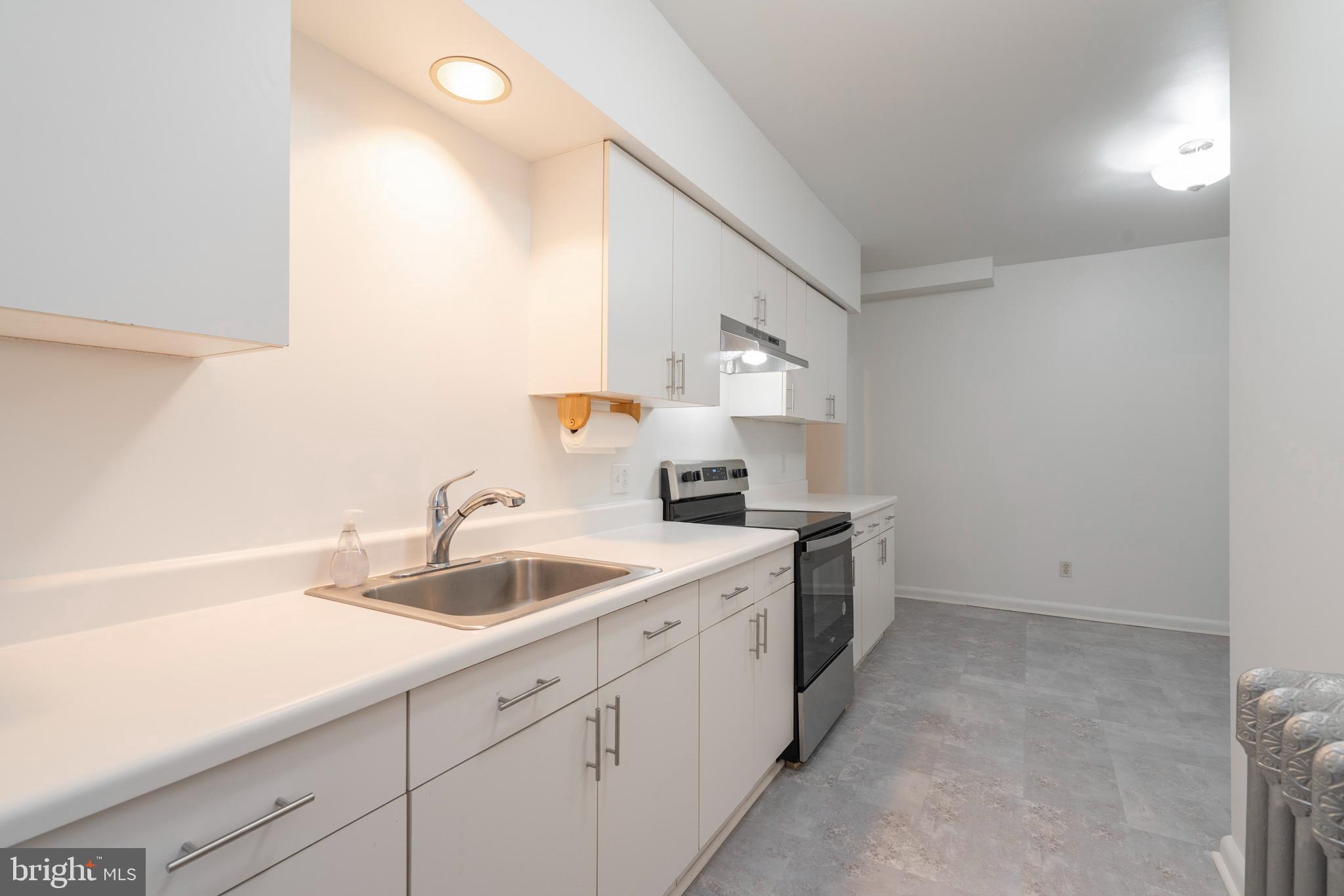 420 Prospect Avenue, Unit 1 Bridgeport, PA 19405 - Photo 8 of 24 a kitchen with a sink cabinets and a window