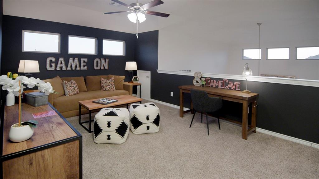 500 Range Road Caddo Mills, TX 75135 - Photo 21 of 35 Spacious loft area featuring carpet flooring, a ceiling fan with integrated lighting, and a half-wall partition