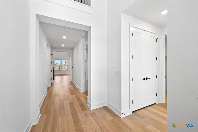 a view of a hallway with wooden floor