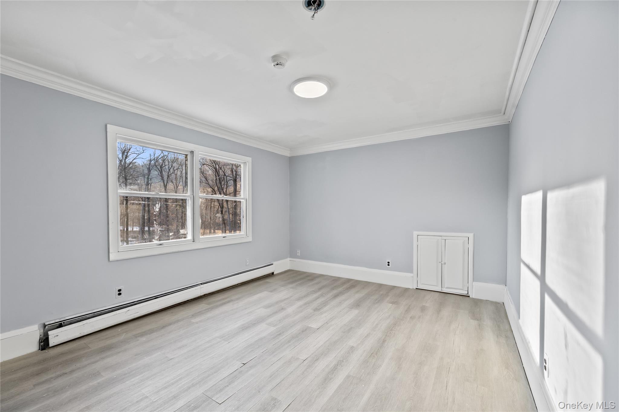 996 Haverstraw Road Suffern, NY 10901 - Photo 22 of 50 a view of an empty room with a window and wooden floor