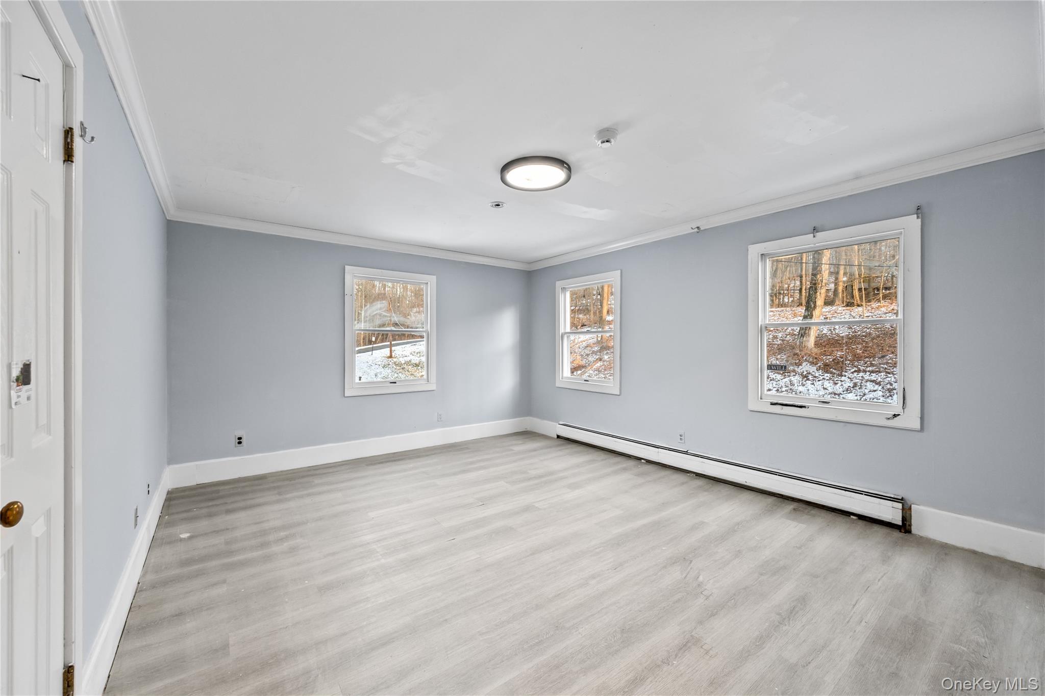 996 Haverstraw Road Suffern, NY 10901 - Photo 24 of 50 a view of an empty room with wooden floor and a window