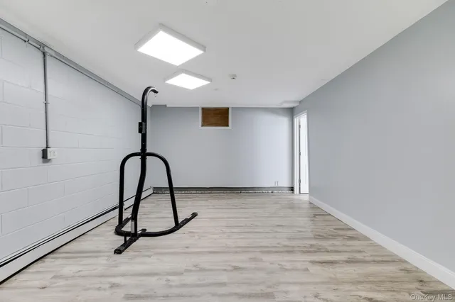a view of a room with a wooden floor and a window