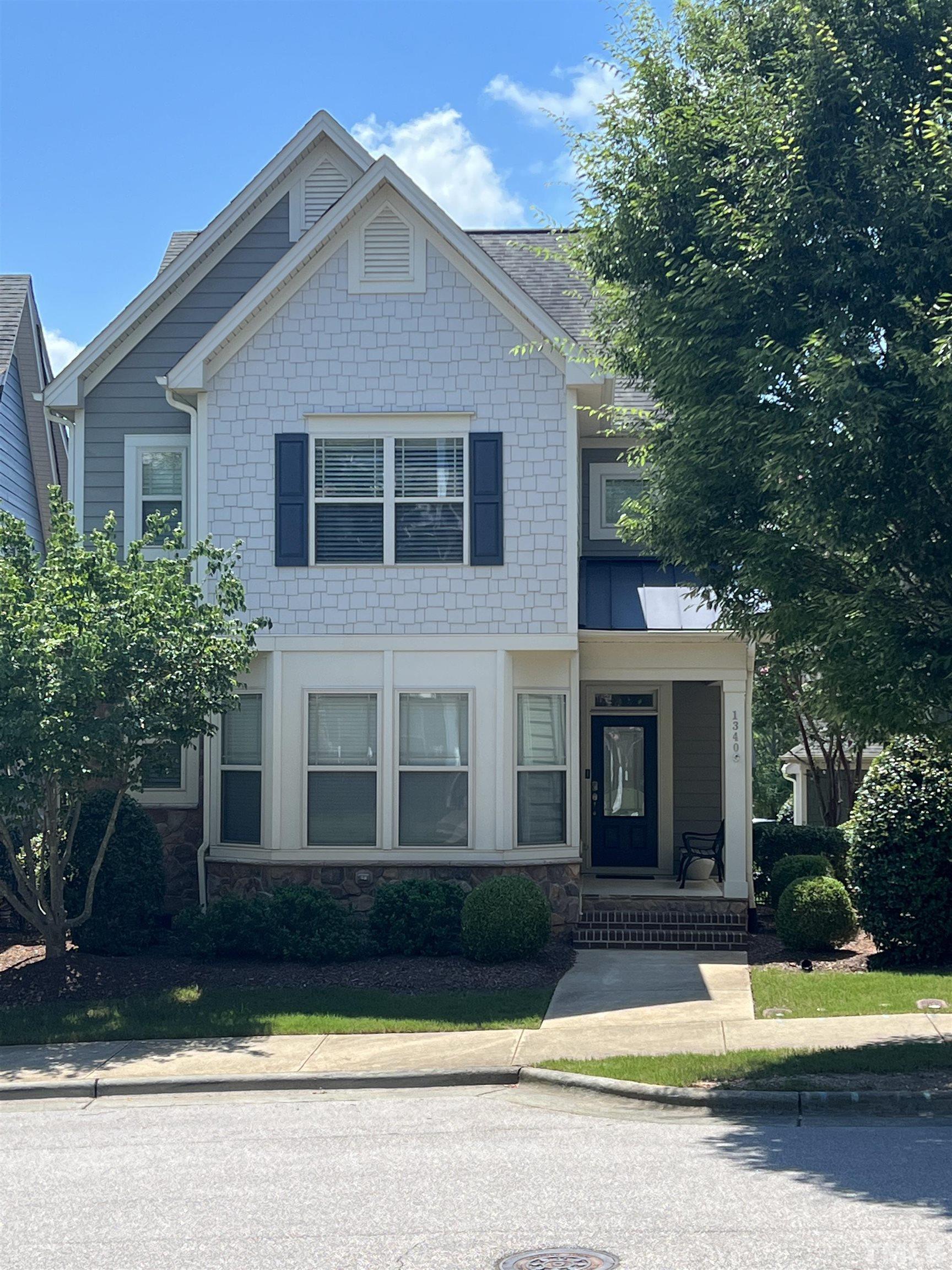 1340 Rodessa Run Raleigh, NC 27607 - Photo 1 of 28 a front view of a house with a yard and trees