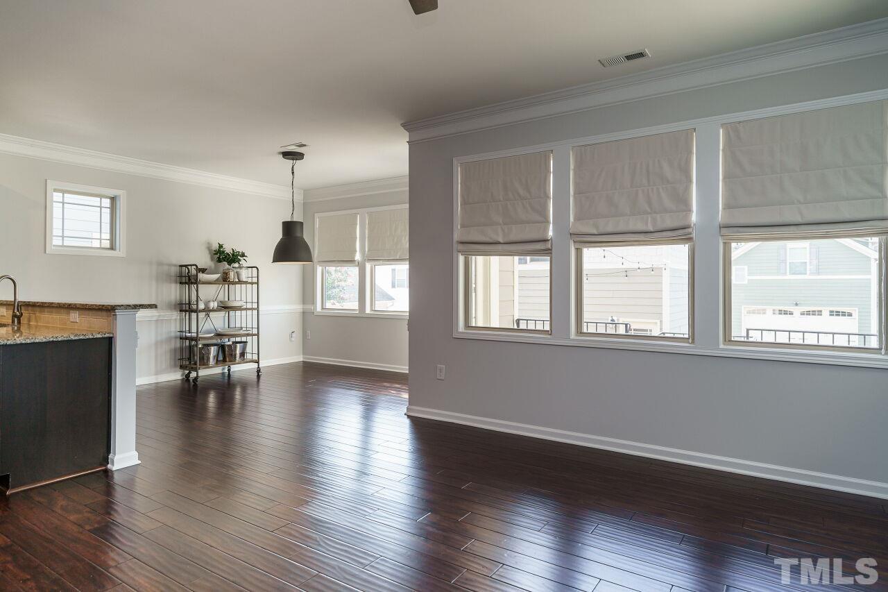 1340 Rodessa Run Raleigh, NC 27607 - Photo 13 of 28 a view of an empty room with wooden floor and a window