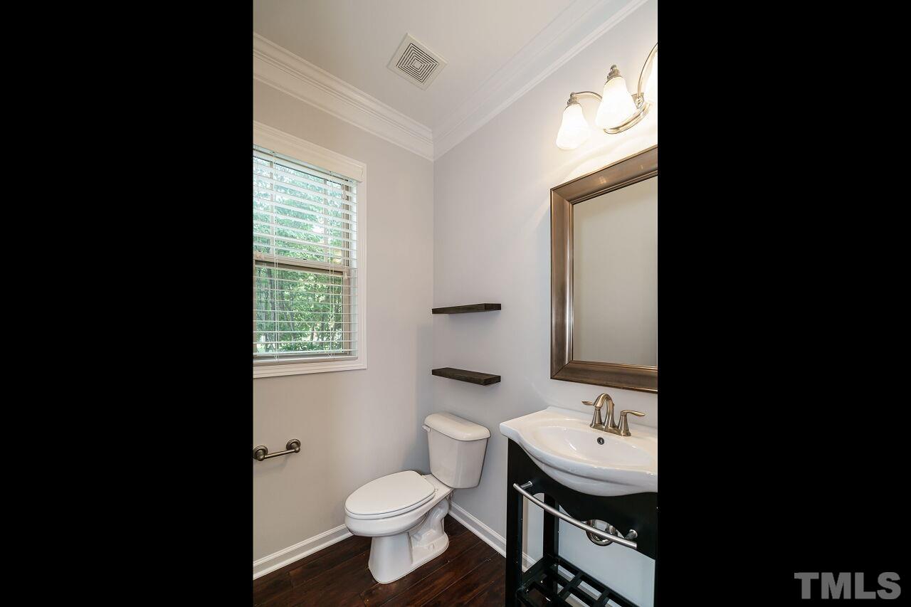 1340 Rodessa Run Raleigh, NC 27607 - Photo 14 of 28 a bathroom with a sink a toilet and mirror