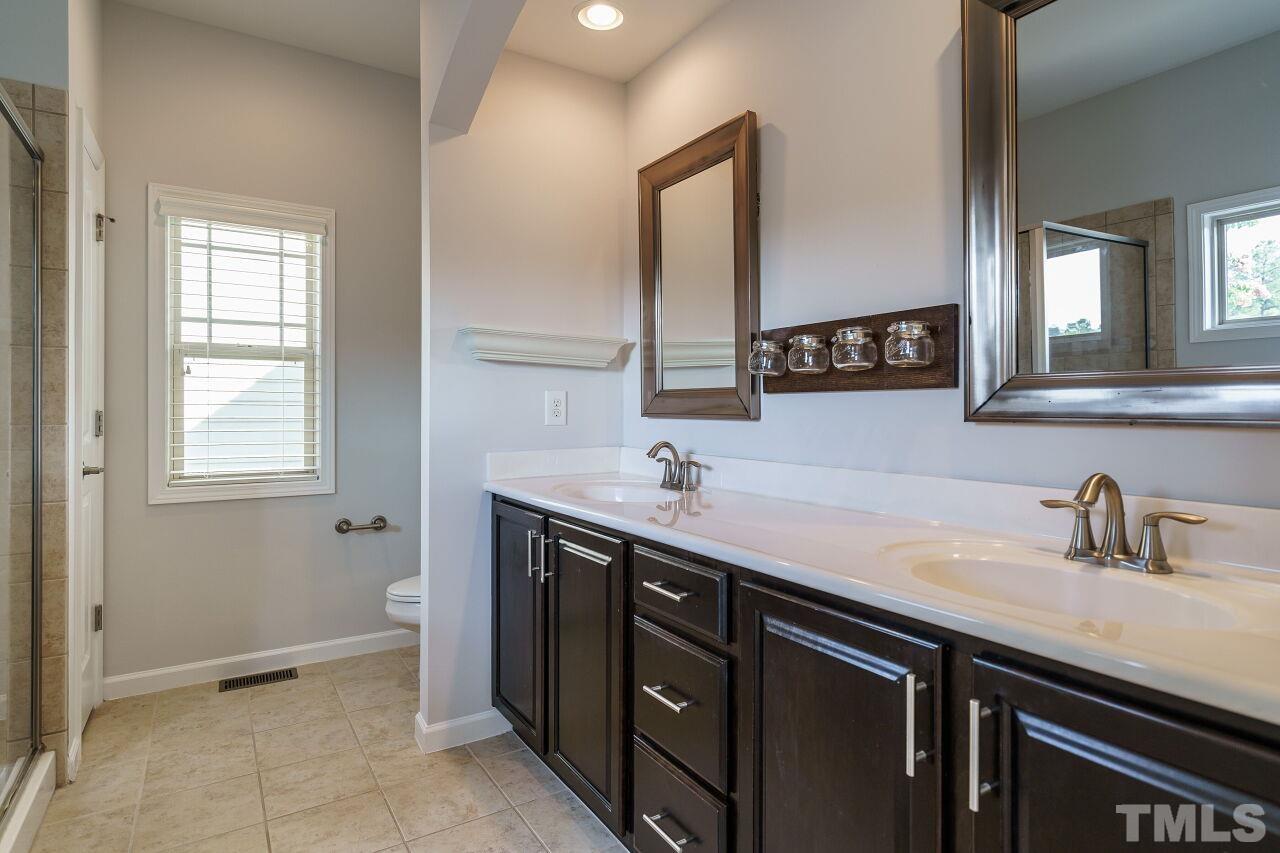 1340 Rodessa Run Raleigh, NC 27607 - Photo 18 of 28 a bathroom with a sink and a mirror