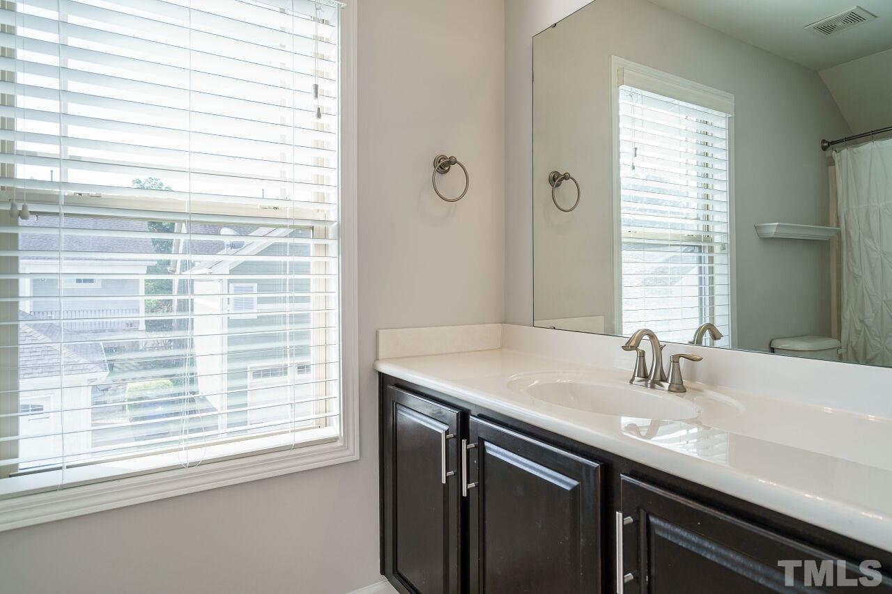 1340 Rodessa Run Raleigh, NC 27607 - Photo 26 of 28 a bathroom with a sink and a mirror