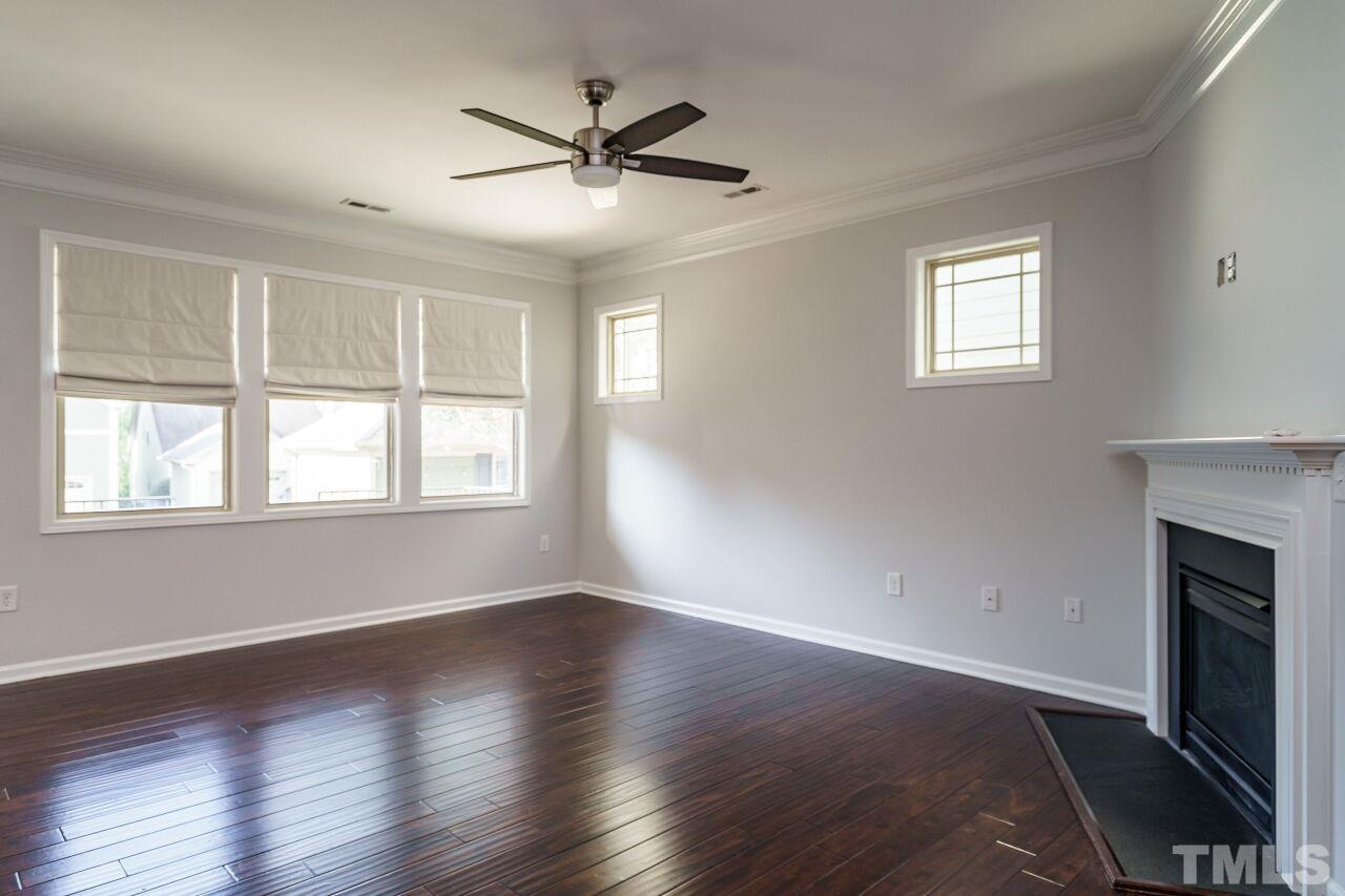 1340 Rodessa Run Raleigh, NC 27607 - Photo 10 of 28 a view of a livingroom with a ceiling fan window and wooden floor