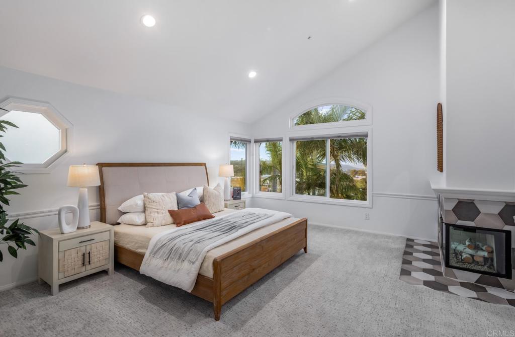 608 Crest Drive Encinitas, CA 92024 - Photo 26 of 33 a bedroom with a bed a mirror and a large window
