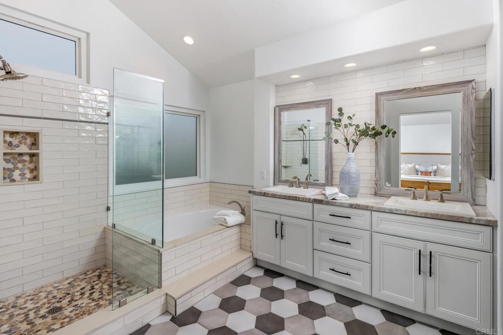 608 Crest Drive Encinitas, CA 92024 - Photo 28 of 33 a bathroom with a double vanity sink a mirror and a bathtub
