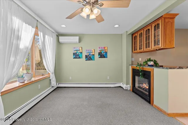 a living room with furniture a fireplace and a chandelier