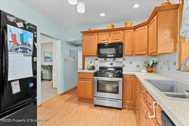 a kitchen with stainless steel appliances a stove sink and microwave