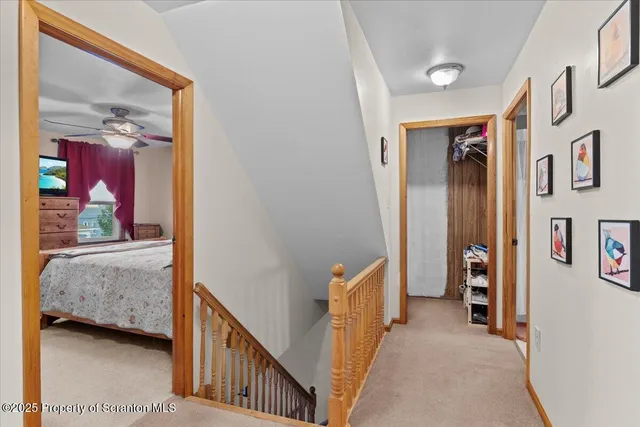 a view of a hallway with wooden floor and entryway