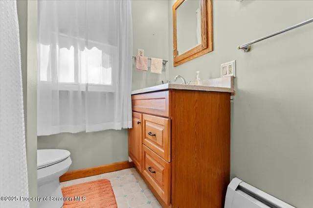 a living room with a bed furniture and a flat screen tv