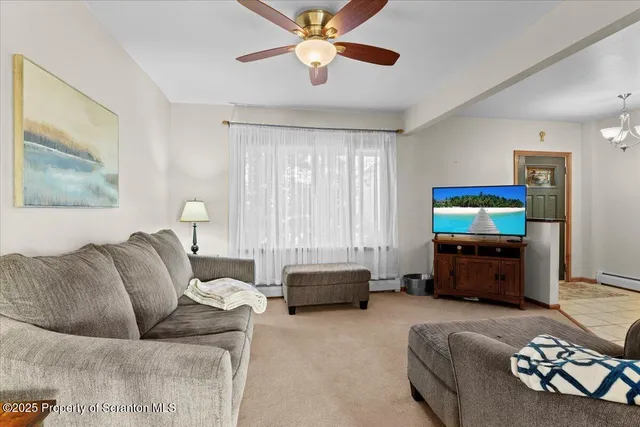 a view of an empty room with a fireplace and window