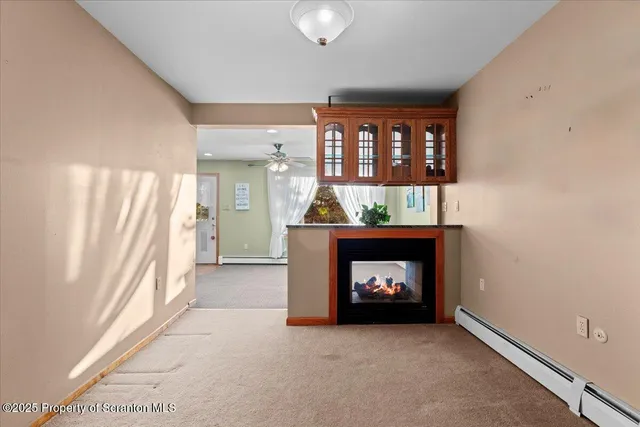 a view of a livingroom and a room and a bathroom