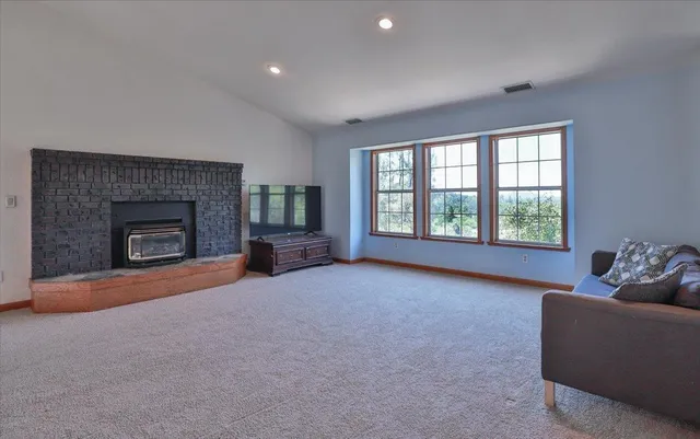 an empty room with furniture and a fireplace