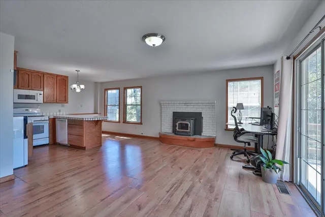 a view of kitchen with livingroom and wooden floor