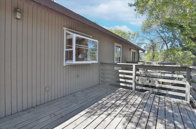 a view of a house with a wooden deck