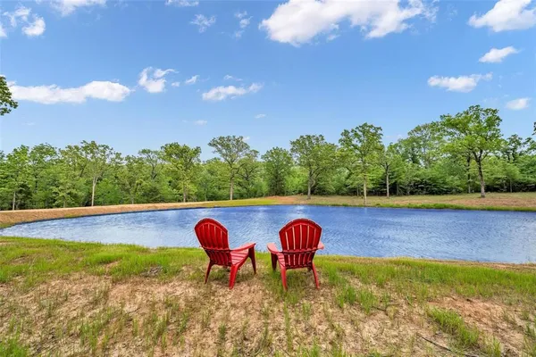 a view of a swimming pool with an outdoor space and seating area