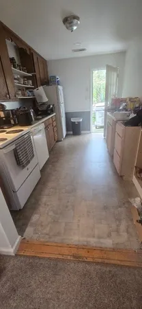 a kitchen with stainless steel appliances kitchen island granite countertop a stove and a sink
