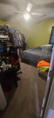 a bed sitting in a bedroom next to a window