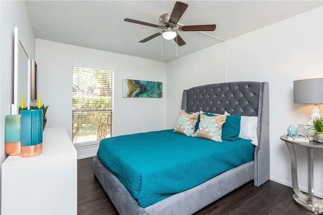 a bed sitting in a bedroom next to a window