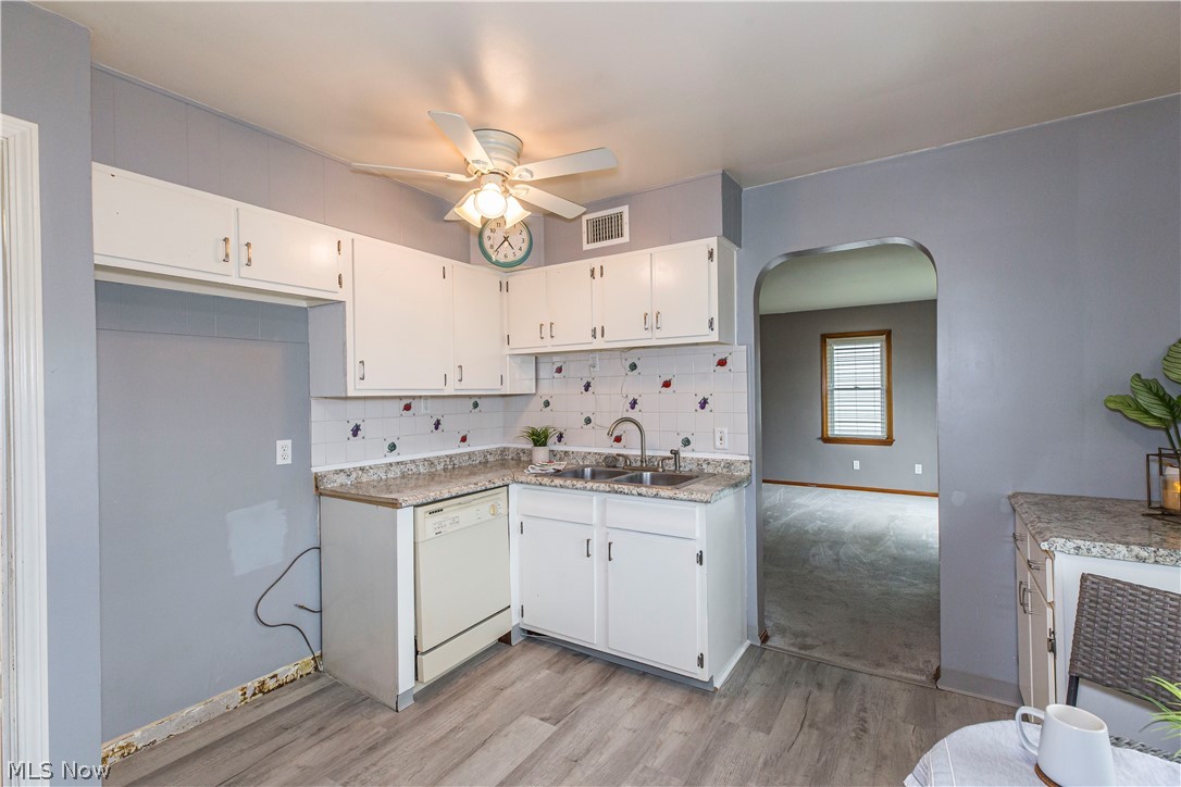 6203 Snow Road Parma, OH 44129 - Photo 5 of 29 Kitchen featuring ceiling fan, dishwasher and white cabinetry