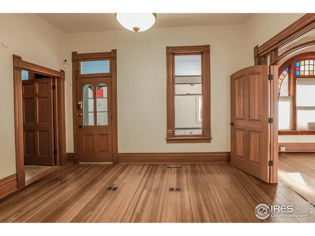 wooden floor in an empty room and a window