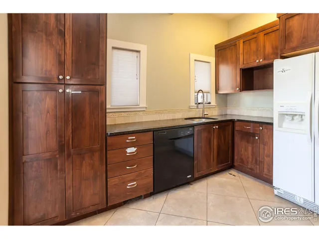 a kitchen with a refrigerator and cabinets