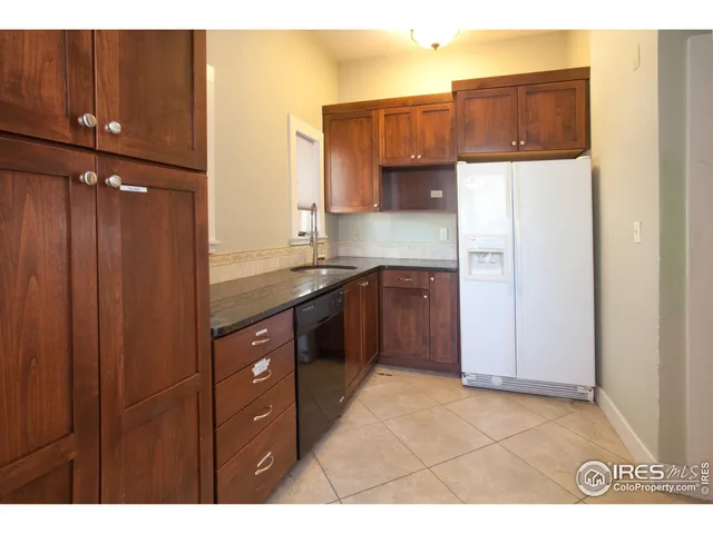 a kitchen with stainless steel appliances granite countertop a refrigerator and a stove