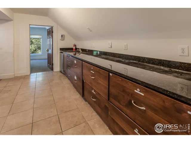a kitchen with granite countertop a stove and cabinets
