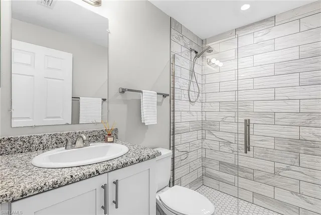 a kitchen with a wooden floor and a ceiling fan
