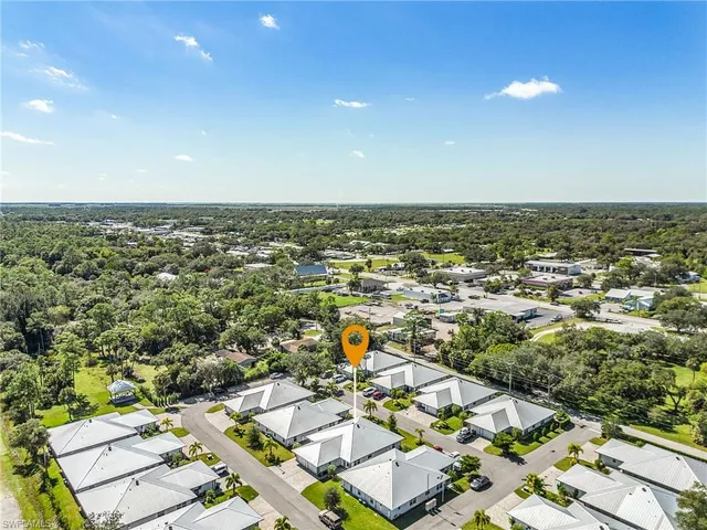 an aerial view of residential houses with outdoor space