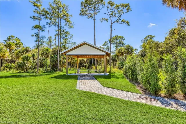 an aerial view of a house with a yard and potted plants