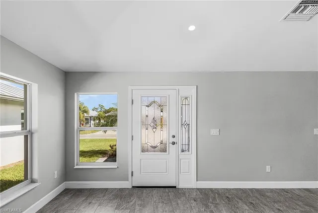 wooden floor in an empty room and a window