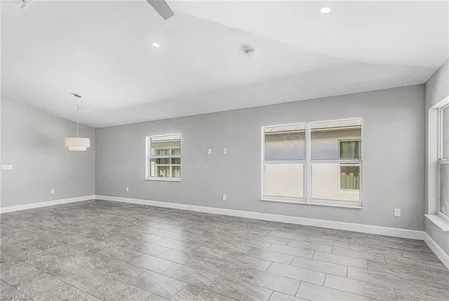 an empty room with windows and closet