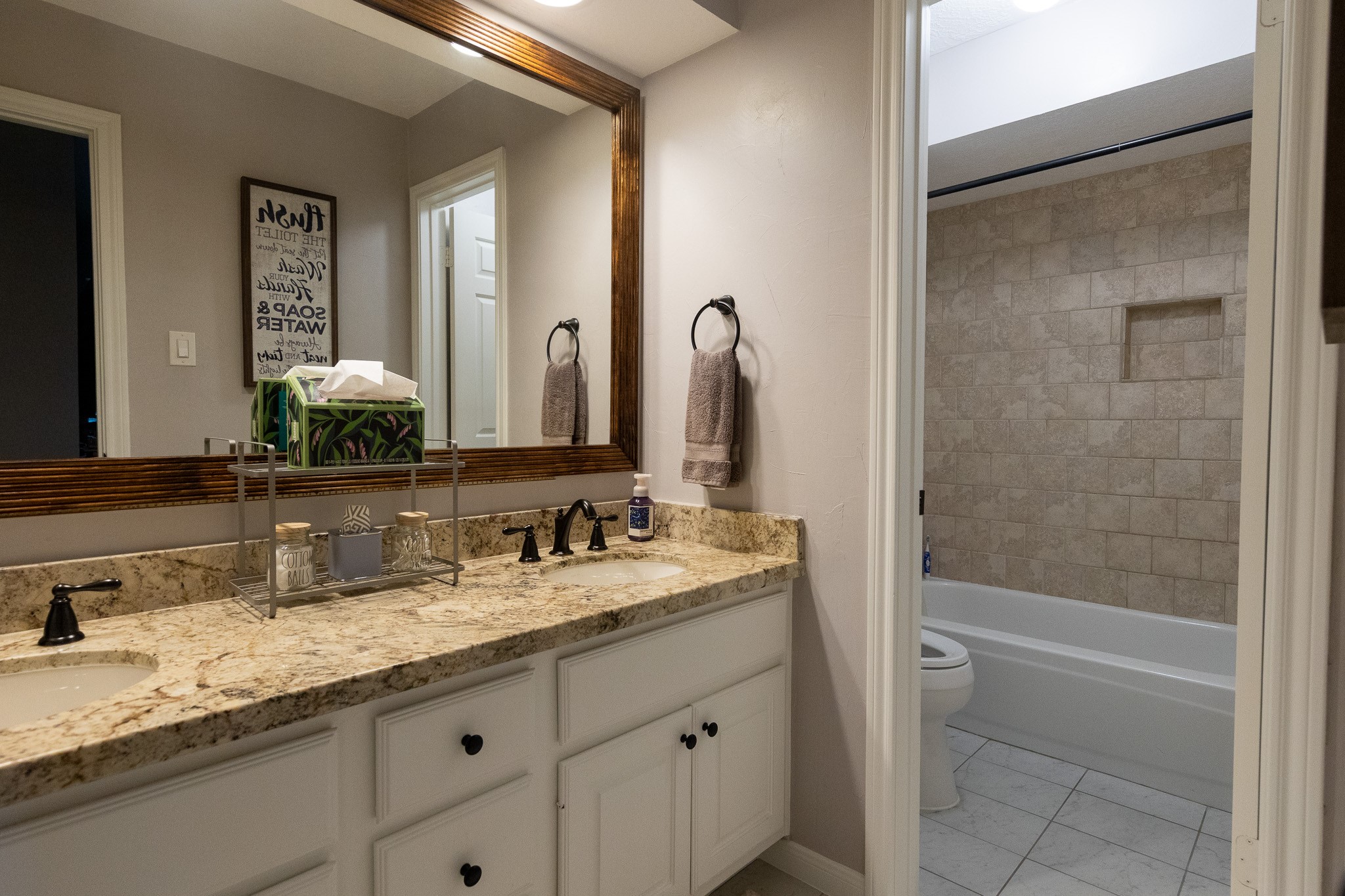 19 Feather Fall Place The Woodlands, TX 77381 - Photo 14 of 20 a bathroom with a granite countertop sink mirror and a bathtub