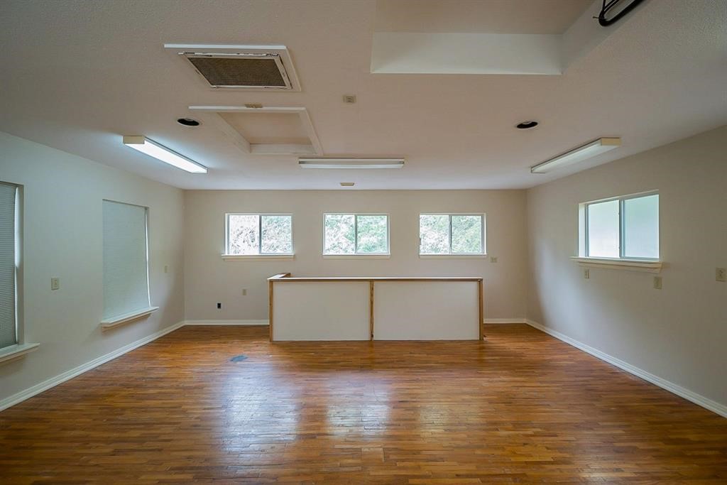 19 Feather Fall Place The Woodlands, TX 77381 - Photo 20 of 20 a view of an empty room with wooden floor and a window