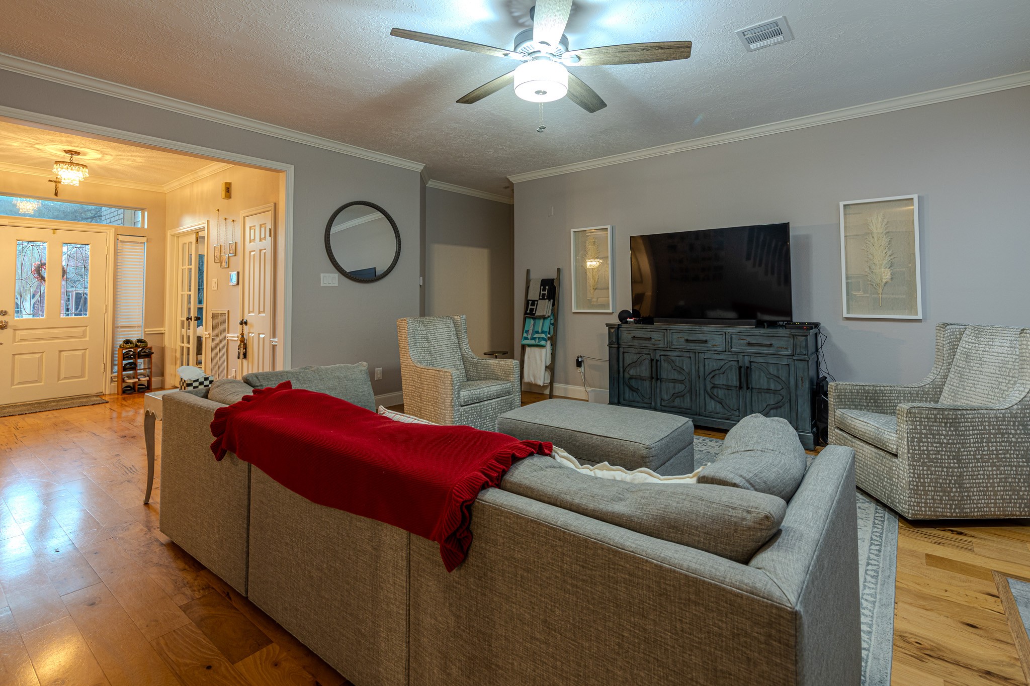 19 Feather Fall Place The Woodlands, TX 77381 - Photo 5 of 20 a living room with furniture a flat screen tv and a large window